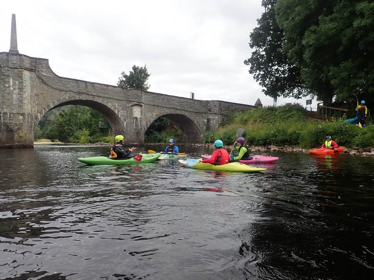 A group of people in kayaks in a river
Description automatically generated with low confidence