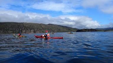 A group of people in kayaks on a body of water

Description automatically generated with medium confidence
