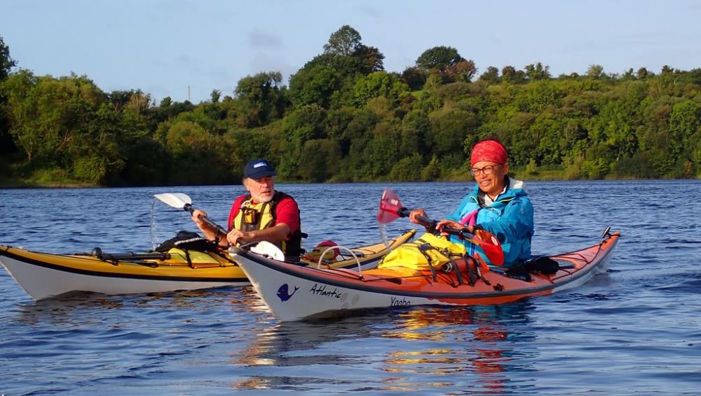 A couple of men in kayaks on water

Description automatically generated