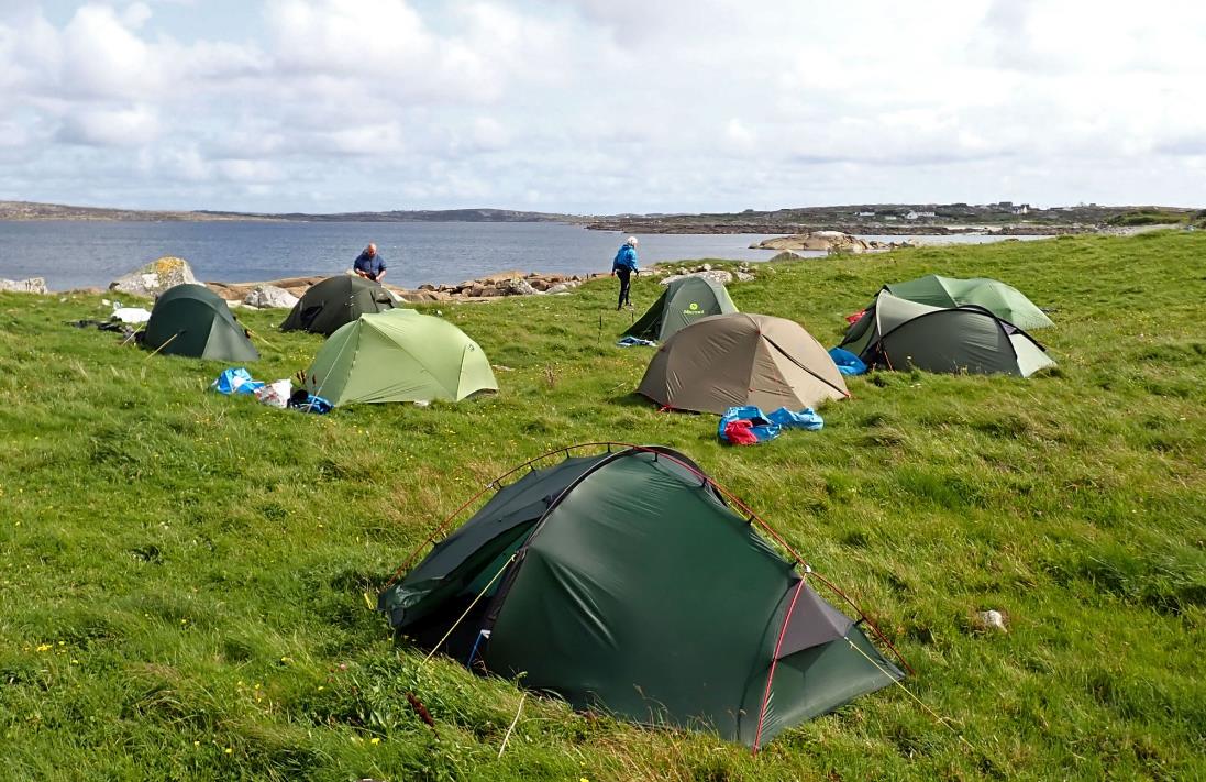 A group of tents on a grassy field

Description automatically generated