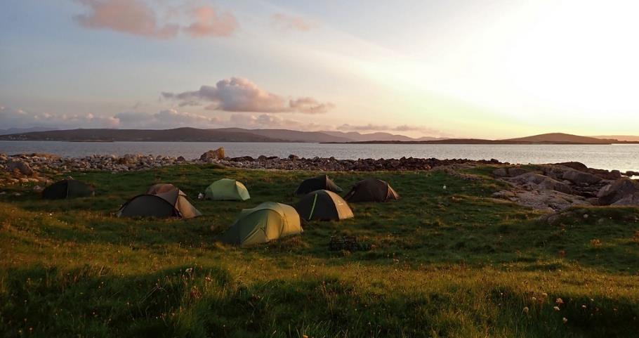 A group of tents on a grassy field

Description automatically generated