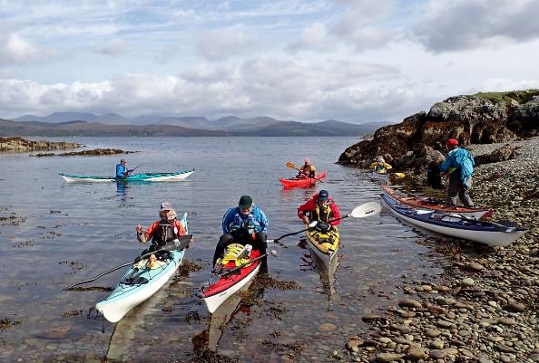 A group of people kayaking in the water

Description automatically generated