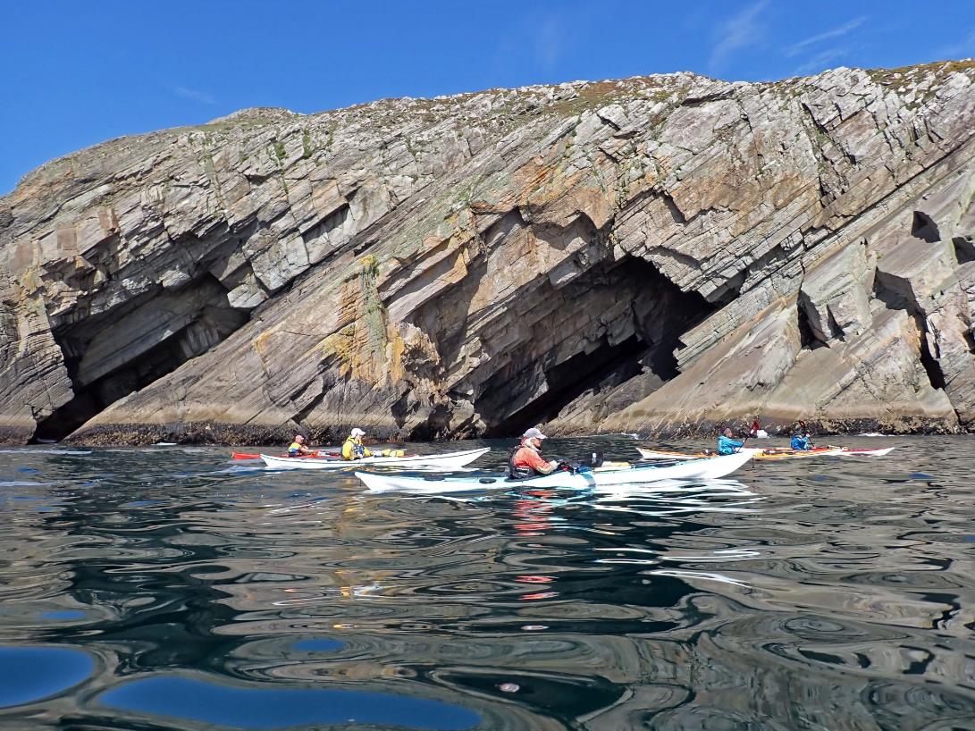 A group of people kayaking in the water

Description automatically generated