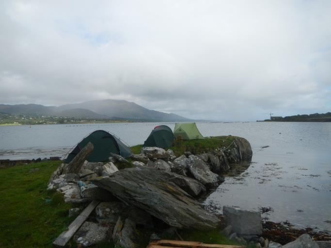 Tents on a rocky shore by the water

Description automatically generated