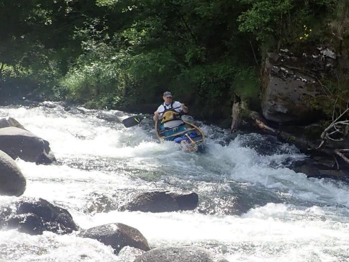 A person in a kayak in a river

Description automatically generated with medium confidence