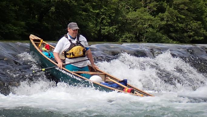A person in a canoe on a river

Description automatically generated with low confidence
