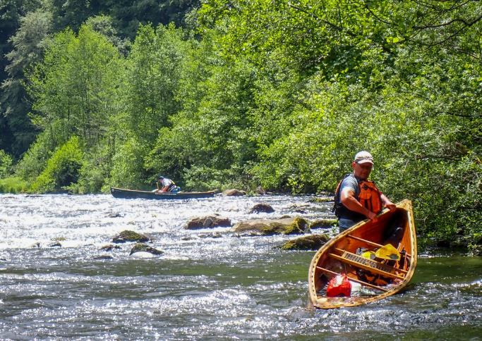A person in a boat in a river

Description automatically generated with low confidence