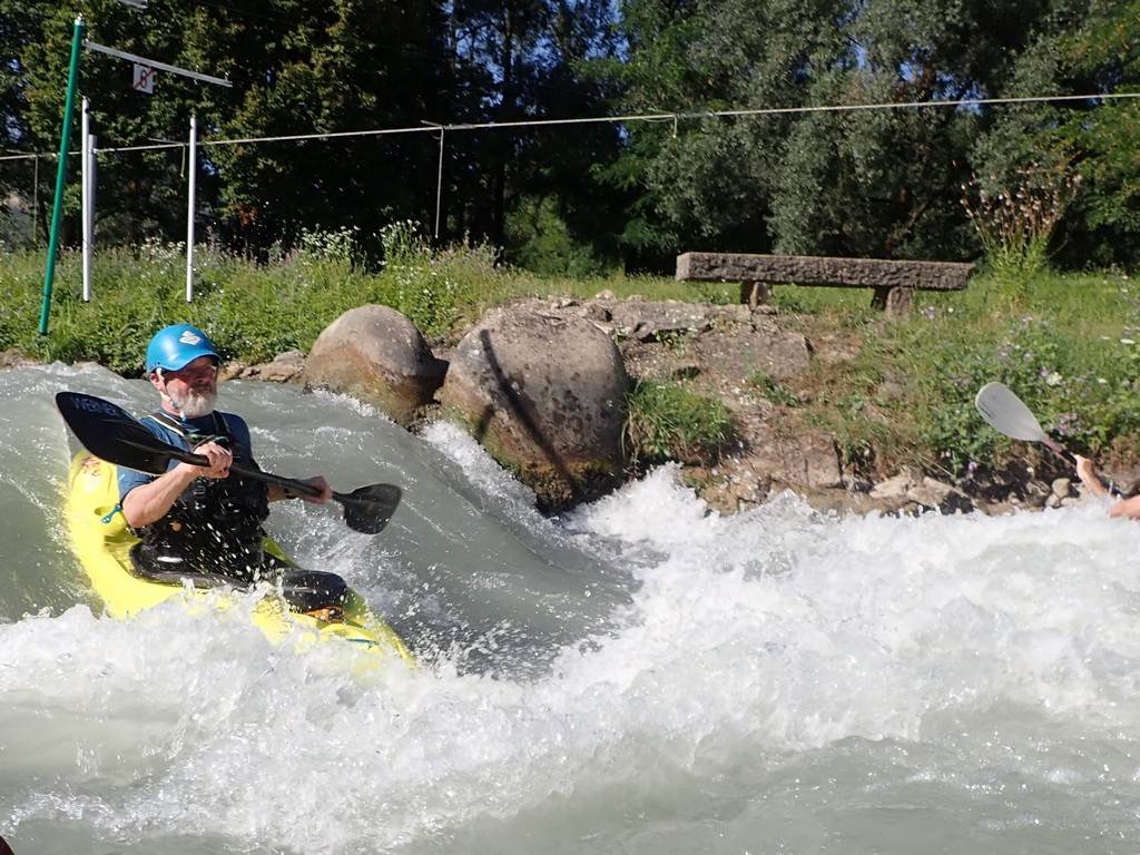 A person in a kayak on a river
Description automatically generated