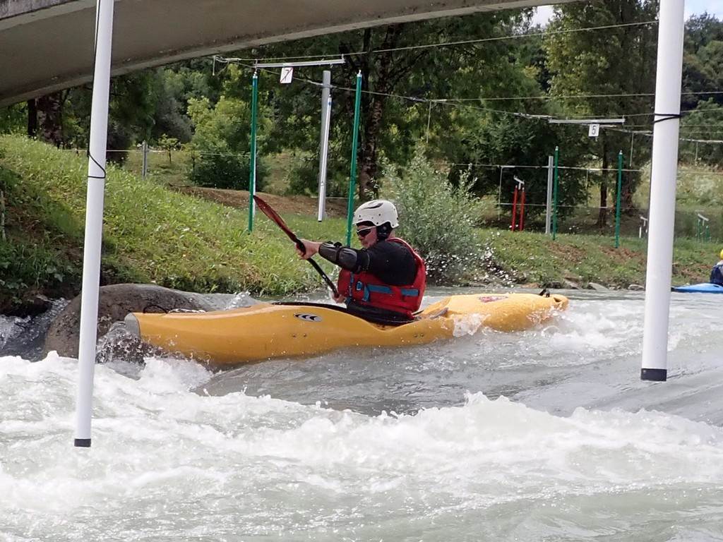 A person in a kayak on a river
Description automatically generated