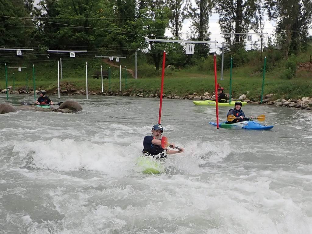A group of people in kayaks in a river
Description automatically generated