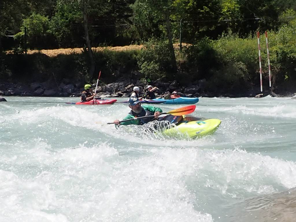 A group of people in kayaks on a river
Description automatically generated