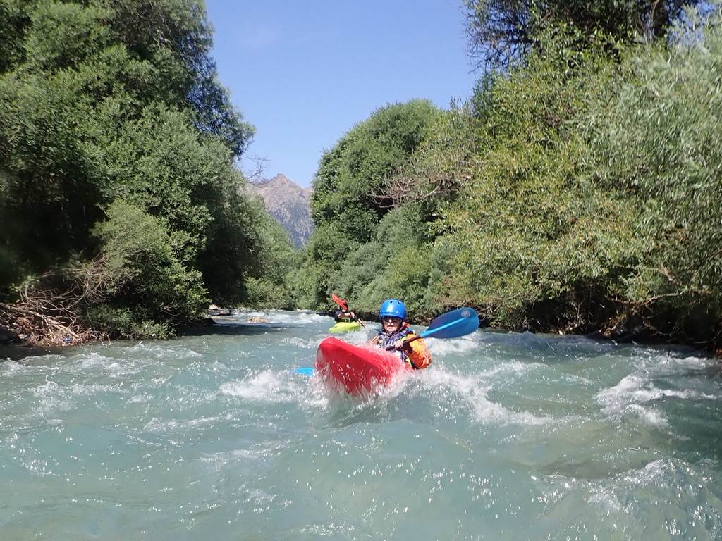 A person in a kayak in a river
Description automatically generated