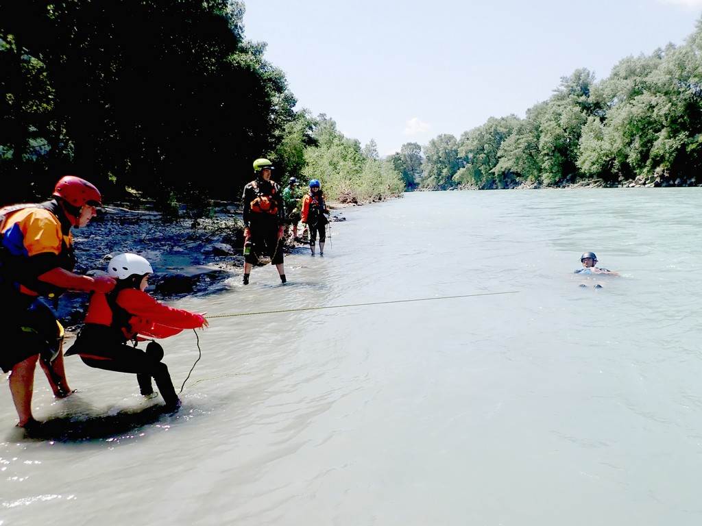 A group of people in water
Description automatically generated