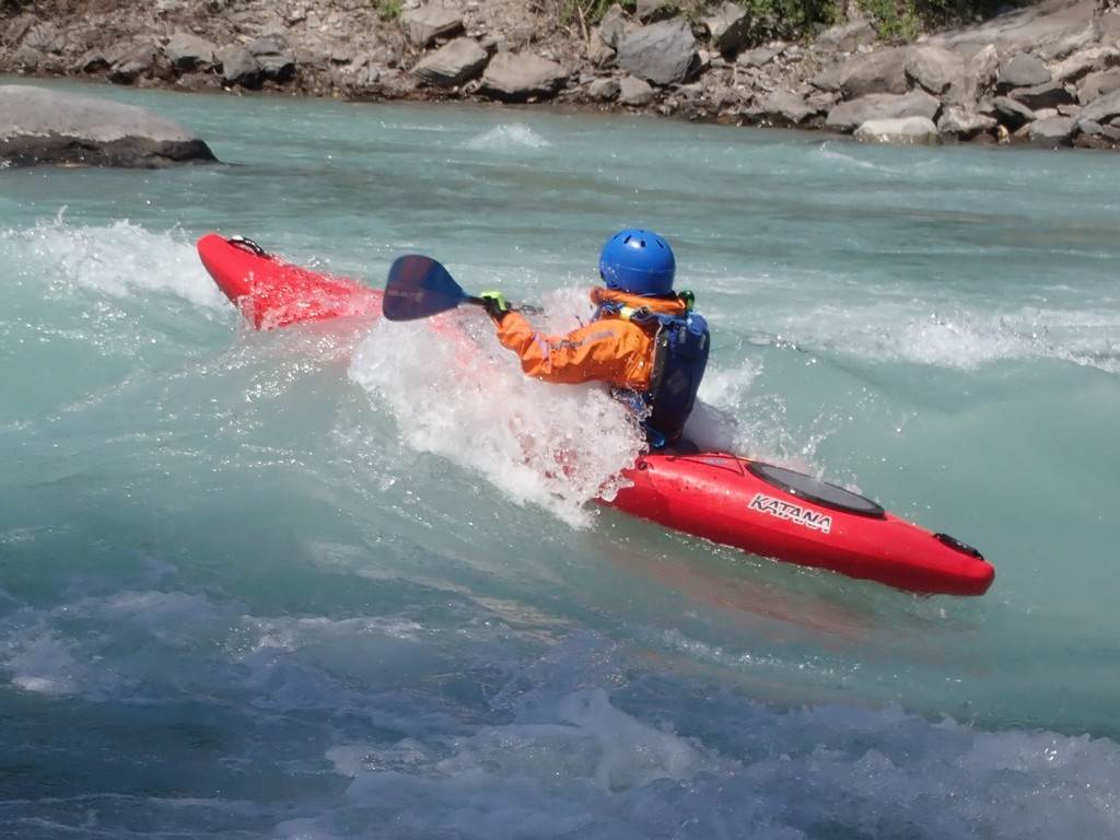 A person in a kayak in the water
Description automatically generated