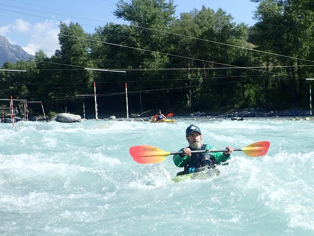 A person in a kayak in a river
Description automatically generated
