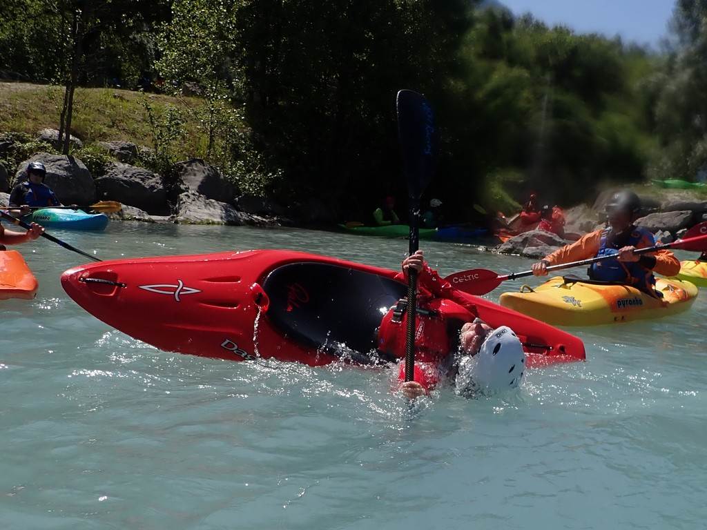A group of people in kayaks in a river
Description automatically generated
