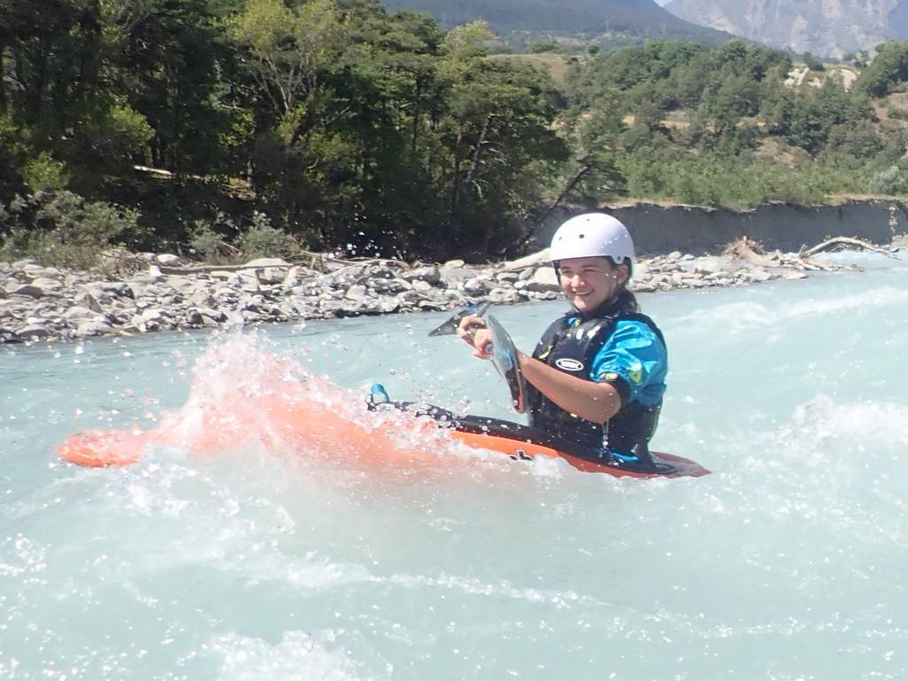 A person on a kayak in a river
Description automatically generated