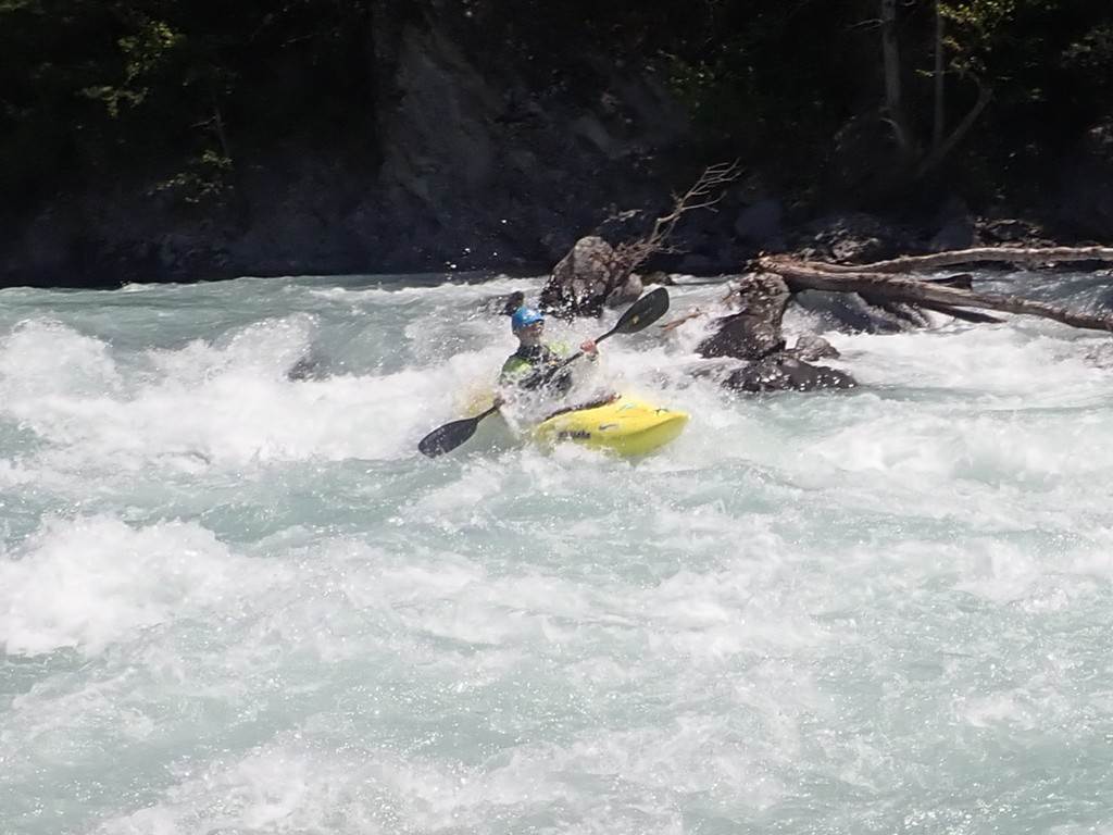 A person in a kayak in a river
Description automatically generated