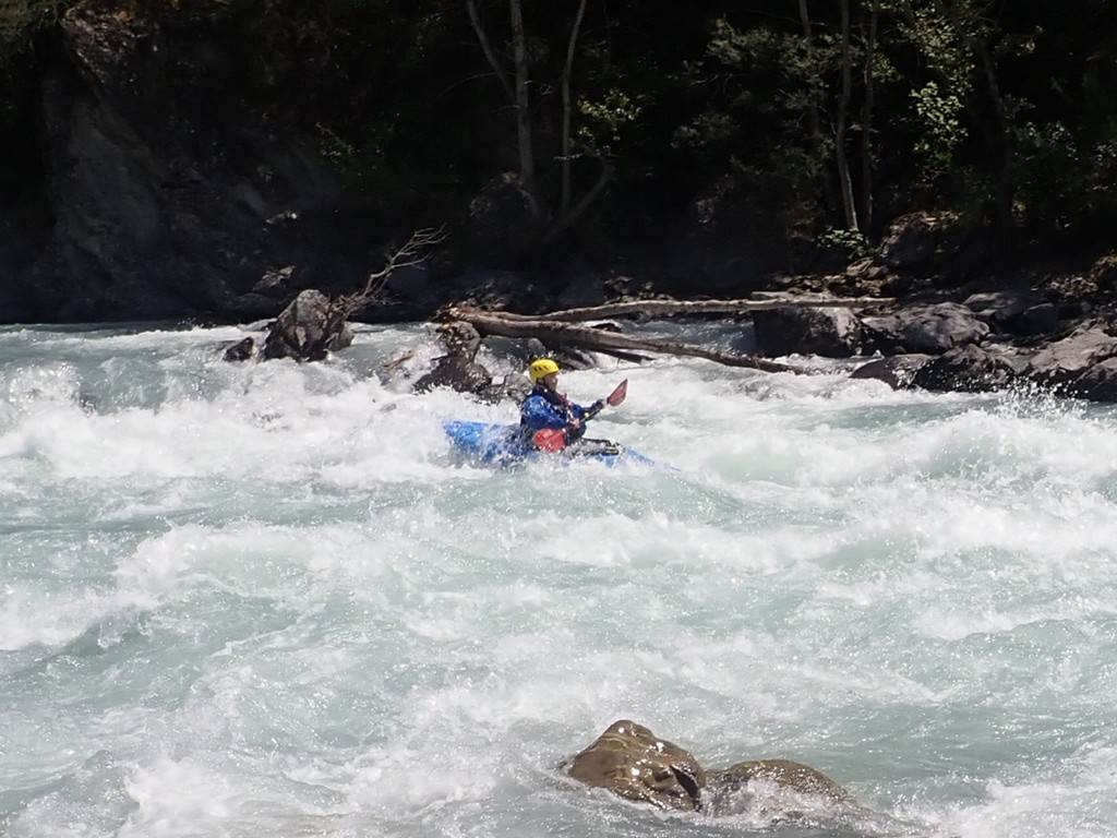 A person in a kayak in a river
Description automatically generated