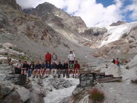 A group of people sitting on rocks

Description automatically generated