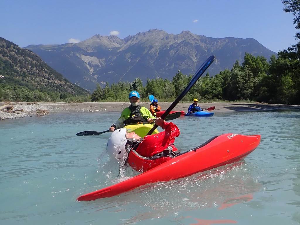 A group of people in a kayak
Description automatically generated