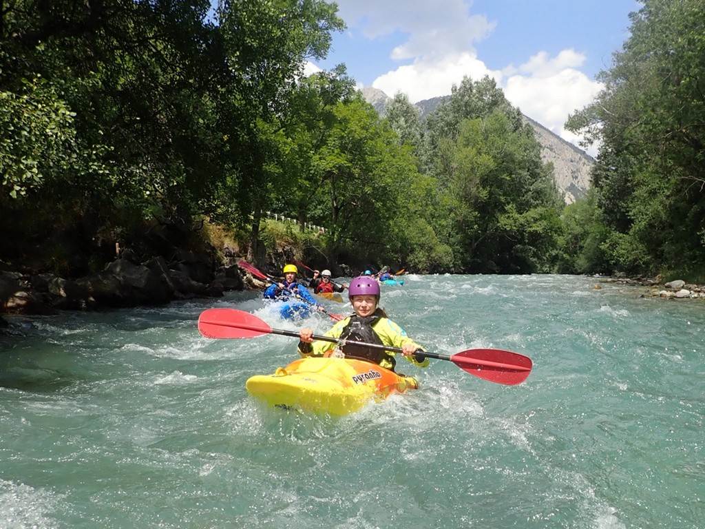 A group of people in a kayak
Description automatically generated