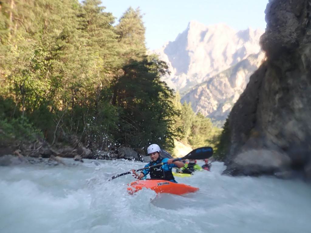A person in a kayak in a river
Description automatically generated