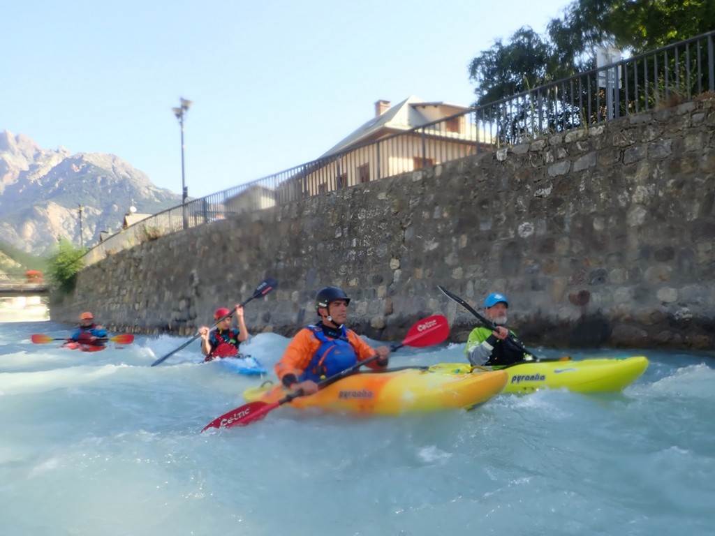 A group of people in kayaks on a river
Description automatically generated
