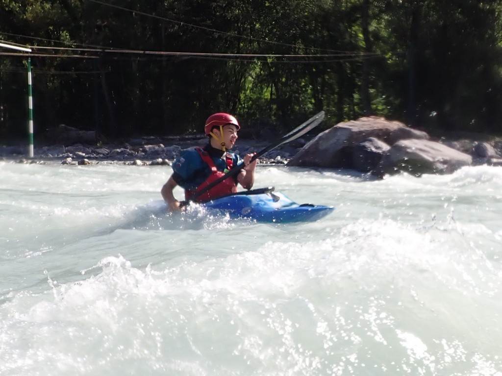 A person in a kayak in a river
Description automatically generated
