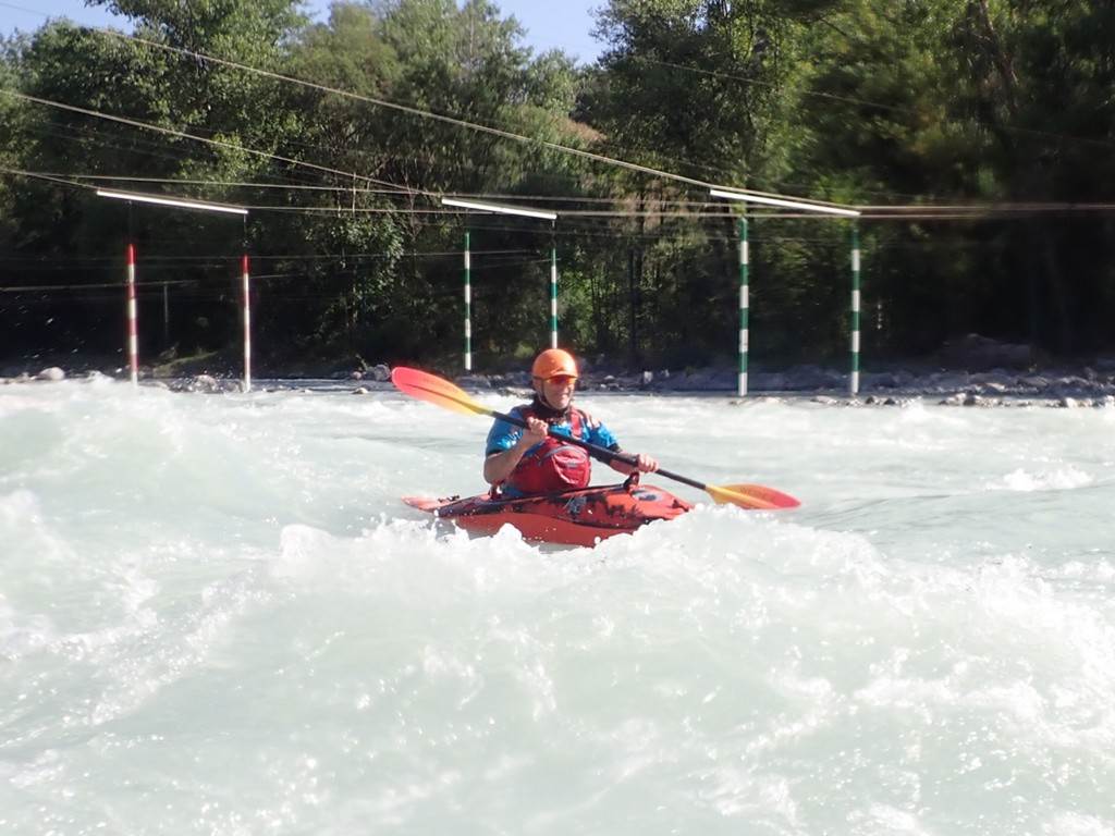 A person in a kayak in a river
Description automatically generated