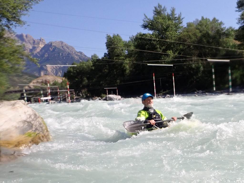 A person in a kayak in a river
Description automatically generated