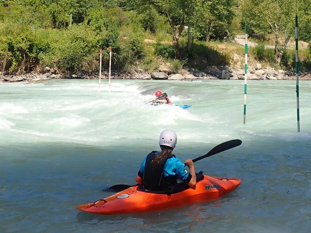 A person in a kayak on a river
Description automatically generated