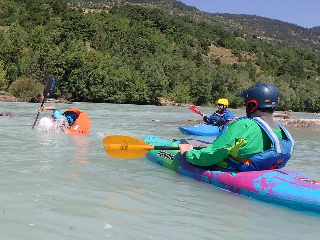 A group of people kayaking in a river
Description automatically generated