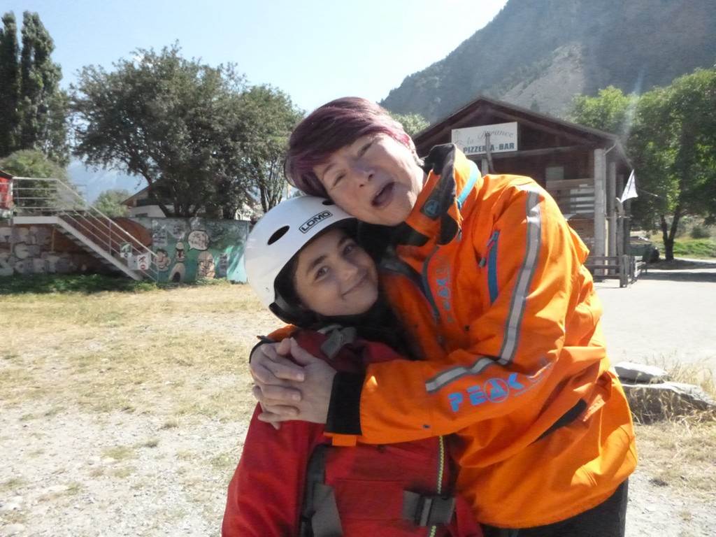 A person hugging a young child
Description automatically generated