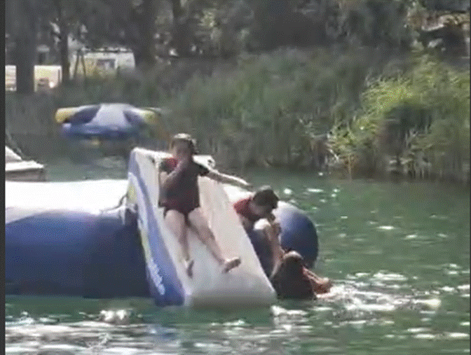 A group of people on a water slide
Description automatically generated