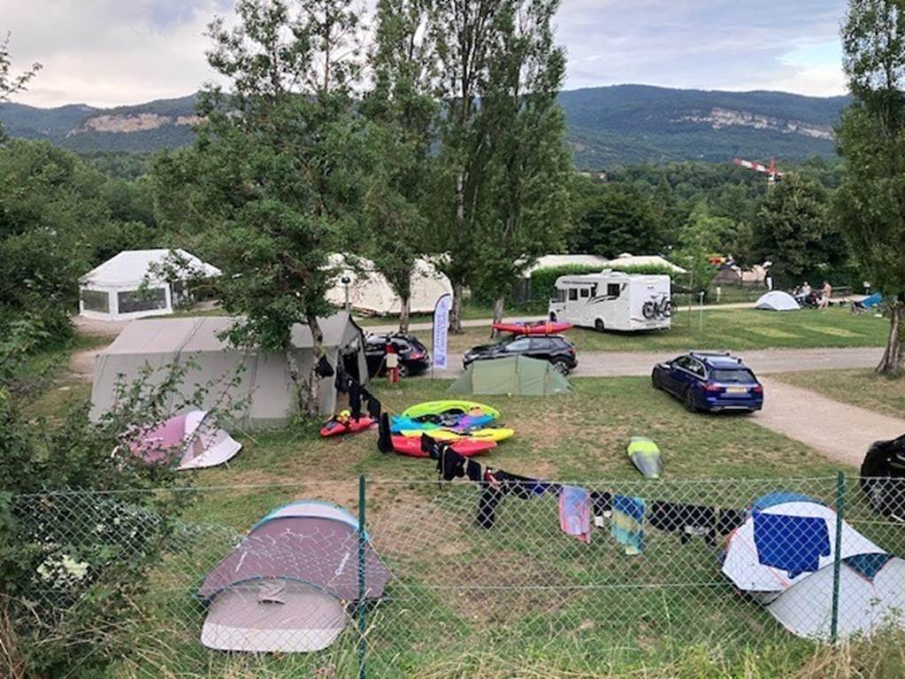 A group of tents and tents in a field

Description automatically generated