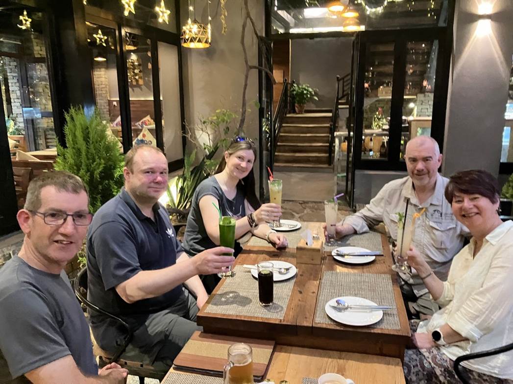 A group of people sitting at a table

Description automatically generated