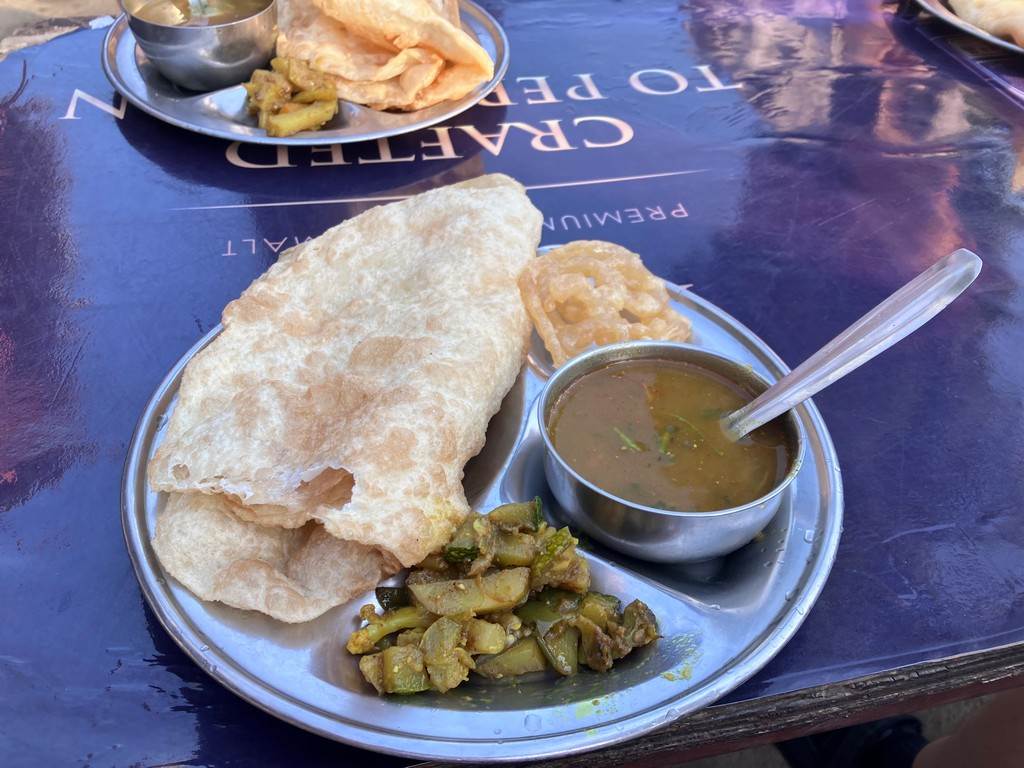 A plate of food with a spoon

Description automatically generated