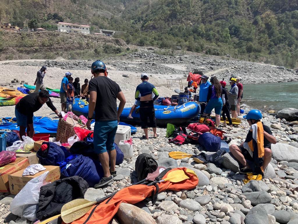 A group of people on a rocky beach

Description automatically generated