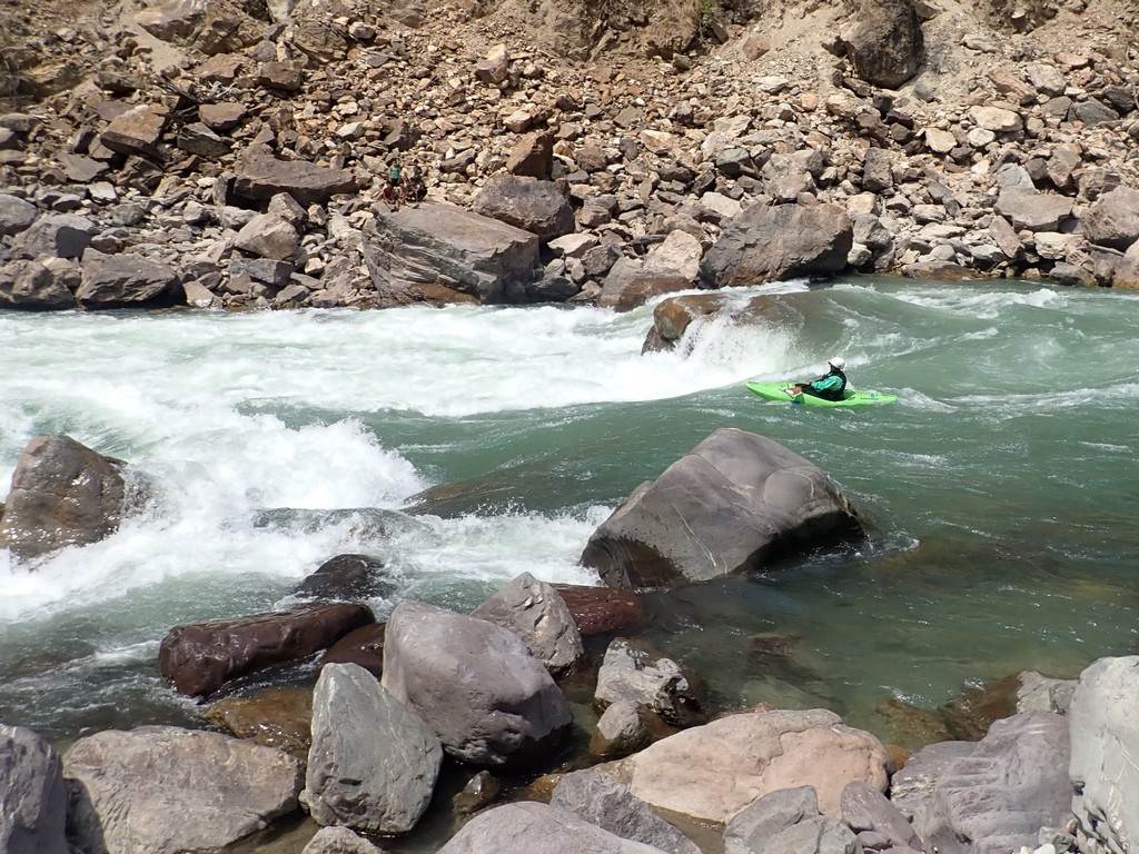 A person in a kayak in a river

Description automatically generated